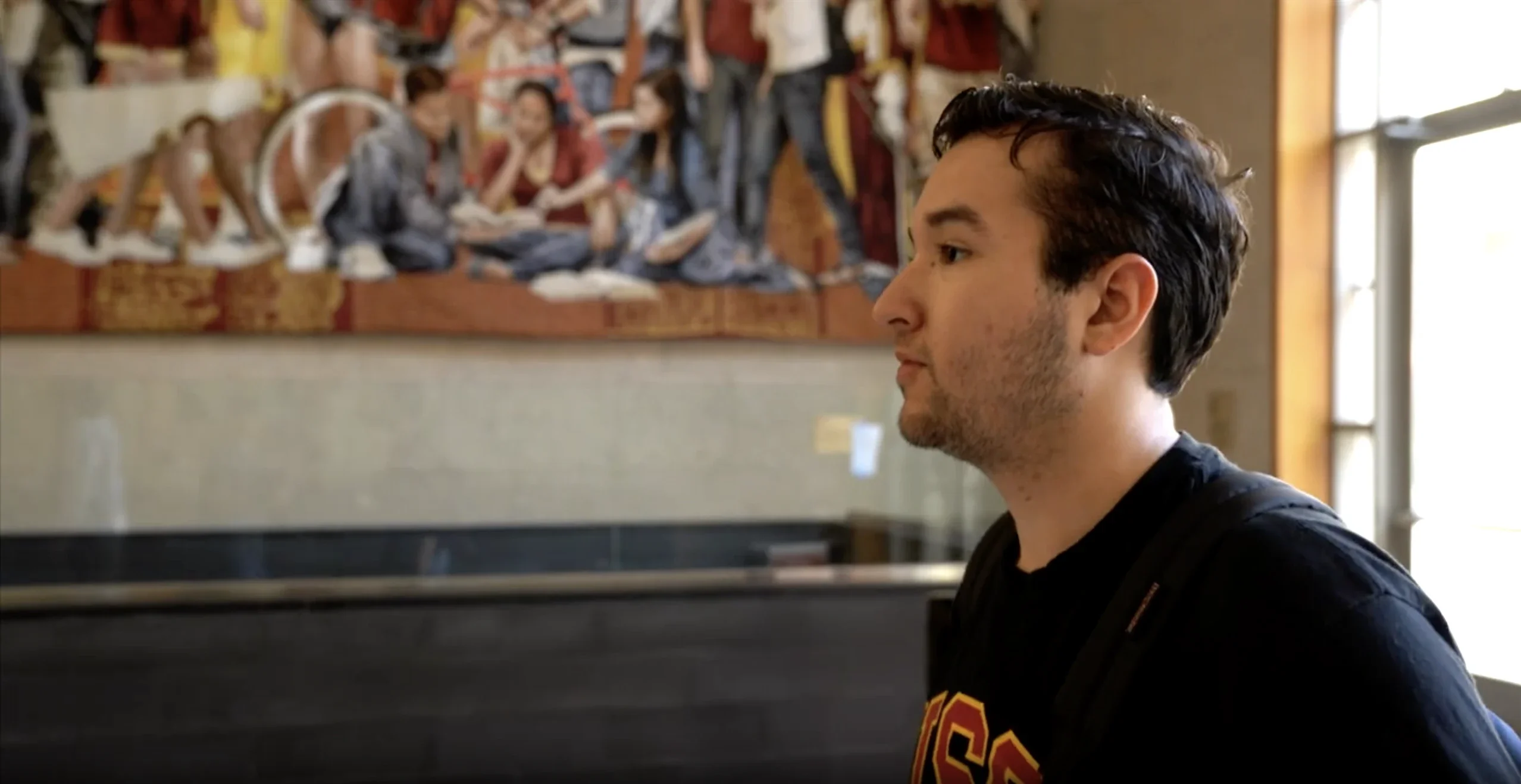 Side profile of a USC student wearing a black shirt