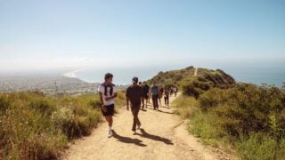 Students hiking in the mountains near the ocean